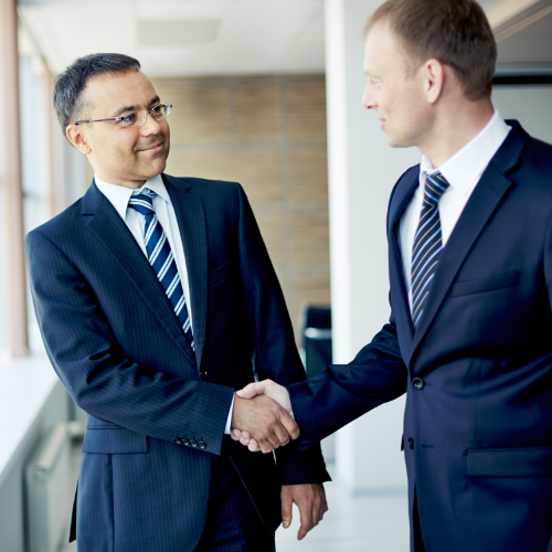 Business Valuation expert and business owner doing handshake